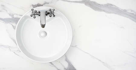 Round bathroom washing sink on marble stone surface, top viewの写真素材