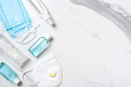 Virus protection concept background with facemasks and hand sanitizer bottlesの写真素材