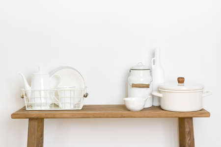 Home decor concept with kitchen utensils and dishware on tableの写真素材