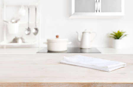 White napkin on table with blurred kitchen cooking zone backgroundの写真素材