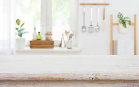 Wood tabletop on blur kitchen background for product display montageの写真素材