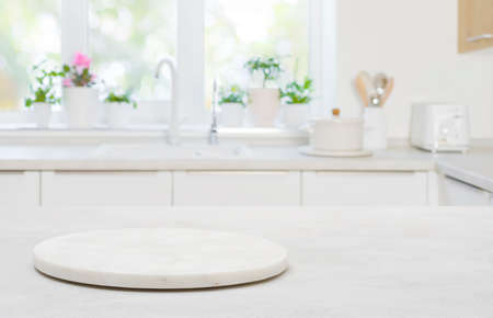 Pedestal for product on wooden table in blurred kitchen interiorの写真素材