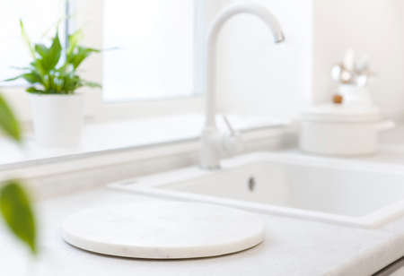 Marble pedestal on blurred kitchen counter sink for product displayの写真素材