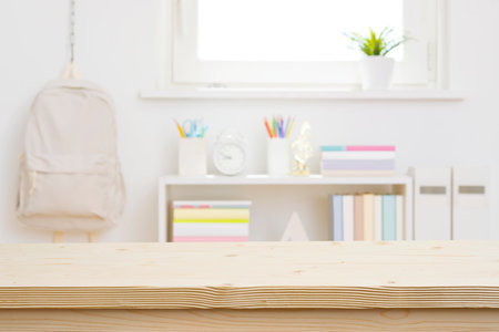 Blank wooden table top on blurred schoolchild room interior backgroundの写真素材