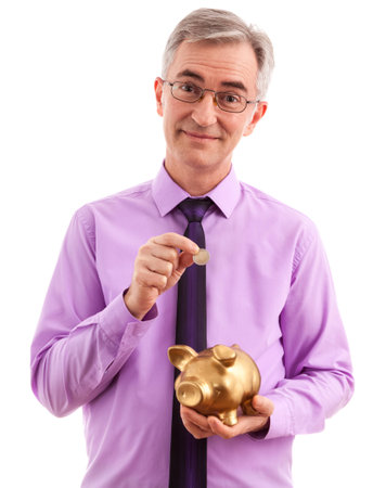 Business man putting coin into piggy bankの写真素材