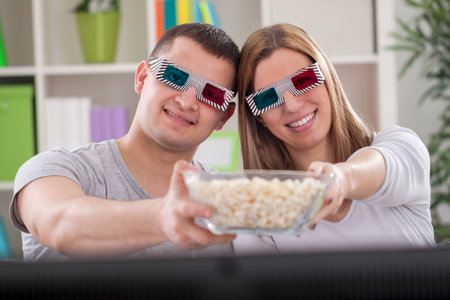 Couple enjoy in movie and holding popcornsの写真素材