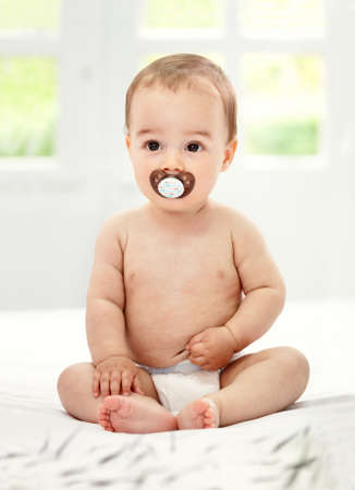 Baby with pacifier in mouthの写真素材