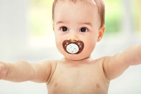 Happy cute baby with pacifierの写真素材
