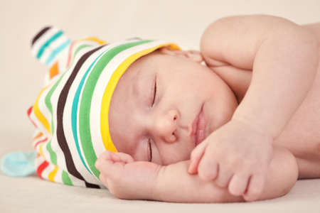 Beautiful gently newborn baby sleeping on blanketの写真素材