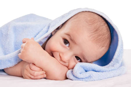 Gently beautiful baby enjoy in bed after bath isolatedの写真素材