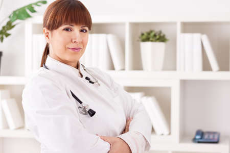 Young beautiful doctor with stethoscope  in office