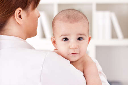 Little cute baby child with doctor pediatricianの写真素材