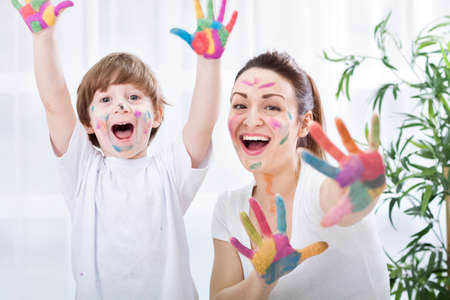 Child painting with mumの写真素材