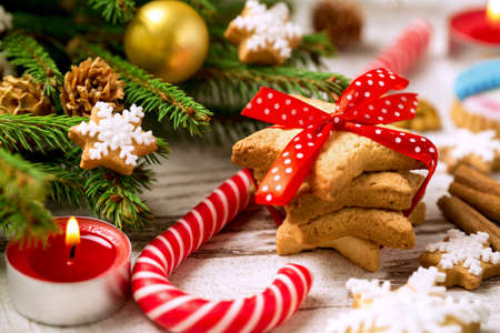 Festive tradition cookies with bow candle and candy close upの写真素材
