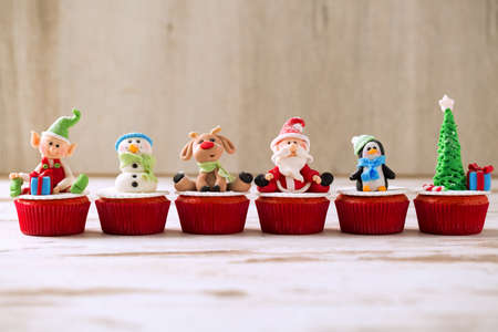 Group of christmas handmade cupcakes on wooden backgroundの写真素材