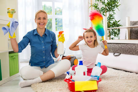 Mother and her daughter ready to room cleaningの写真素材