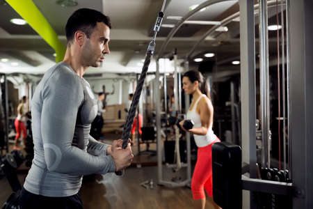 Muscular couple doing powerful exerciseの写真素材