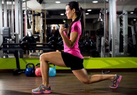 Young beautiful woman at gymの写真素材