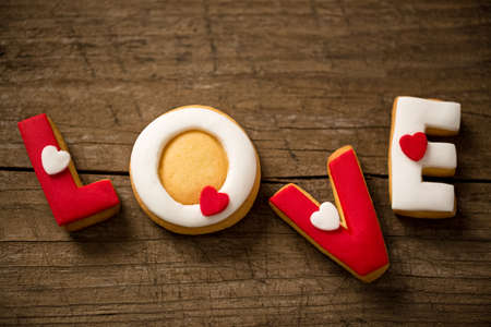 Love cookies on wooden background, valentine conceptの写真素材
