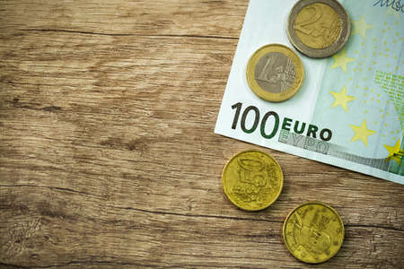 Money with coins on wood backgroundの写真素材