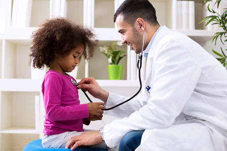 Pediatrician and little african girl at hospitalの写真素材
