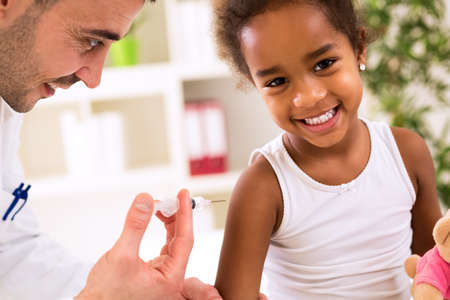 Little happy girl get an injection, vaccinationの写真素材