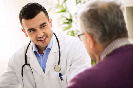 Old sick man visit doctor, patient careの写真素材