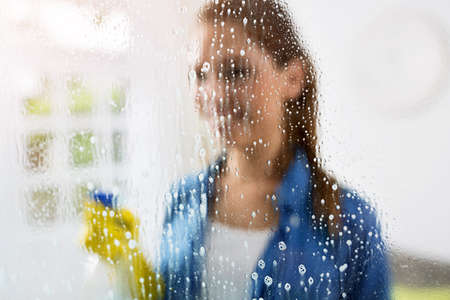 Cleaning window pane with detergentの写真素材