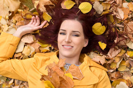 Attractive woman relax in a beautiful autumn leaves