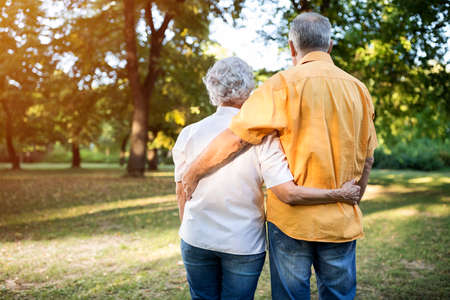 Senior handsome and lovely couple walking outdoorsの写真素材