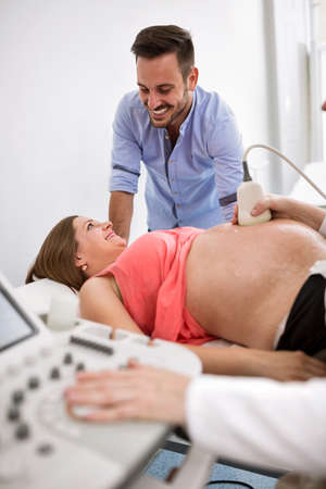 Adorable smiling lovely pregnant woman and the future happy father