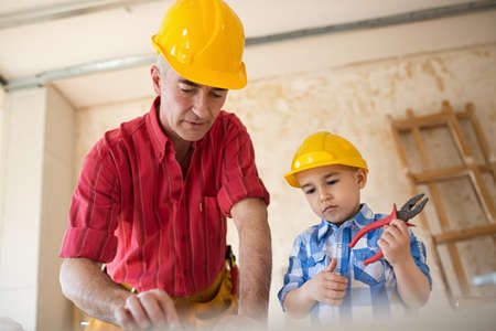 Grandfather and grandson as a dream team in the workshop, closeupの写真素材