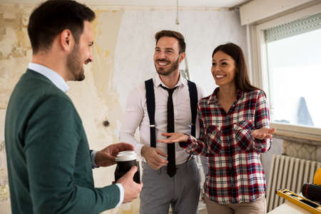 Caring colleague brings coffee for his team of engineers on construction site