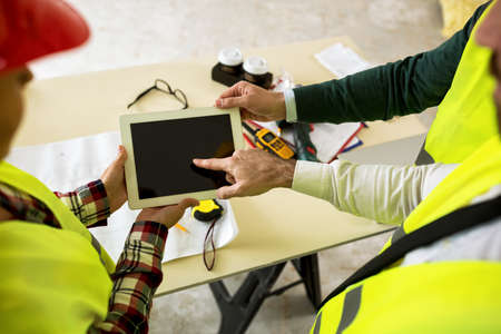 Group of engineers with tablet at construction siteの写真素材