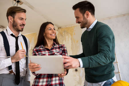 Group of engineers with tablet at construction siteの写真素材