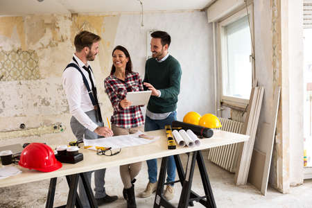 Three young architects working on a project reconstruction of the buildingの写真素材