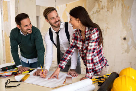 Three young architects working on a project reconstruction of the buildingの写真素材