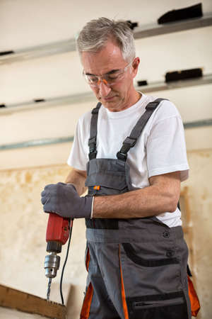 Carpenter used drills  in reparation of old doors in workshopの写真素材