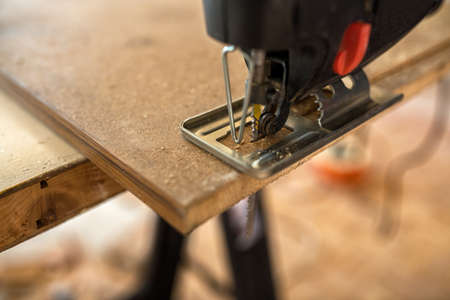 Restoration of old doors with jigsaw, close upの写真素材