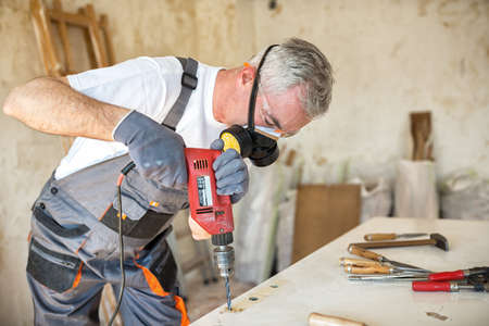Carpenter restores old door in workshop, close upの写真素材