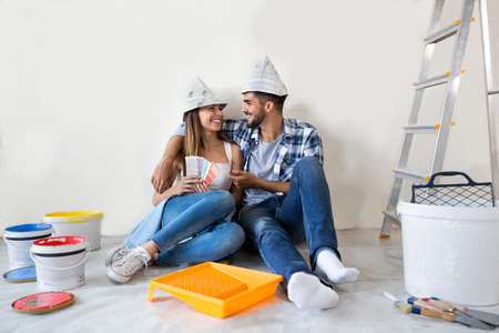 Couple doing home renovations choosing colors and enjoy in new apartmentの写真素材