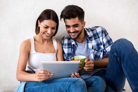 Couple enjoy and smiling while using tabletの写真素材