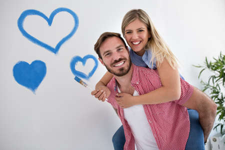 Happy young couple relaxing after paintingnew homeの写真素材