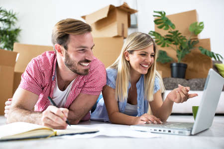 Young couple is planning to equip a new home, shopping furniture onlineの写真素材