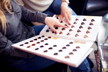 What color to pick this time, two women visit hair beauty salon to make new stylingの写真素材