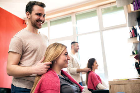 Smiling hairdresser and customer in woman hair salonの写真素材