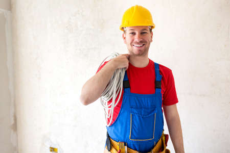 Electric cable placement on a working site performed by a handymanの写真素材