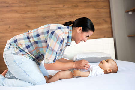 Gentle play of mom and her kid on the couch in the living room