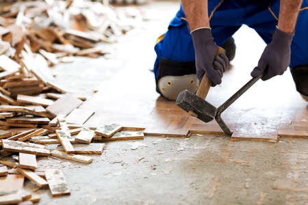 Hammer, crowbar and a pile of old flooring shot all together on the construction site