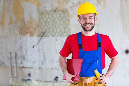 Building worker posing for a photo inside of an construction site